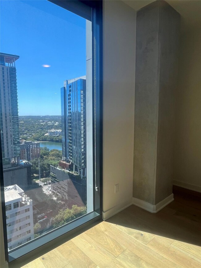 Spare room featuring a view of city, wood finishe