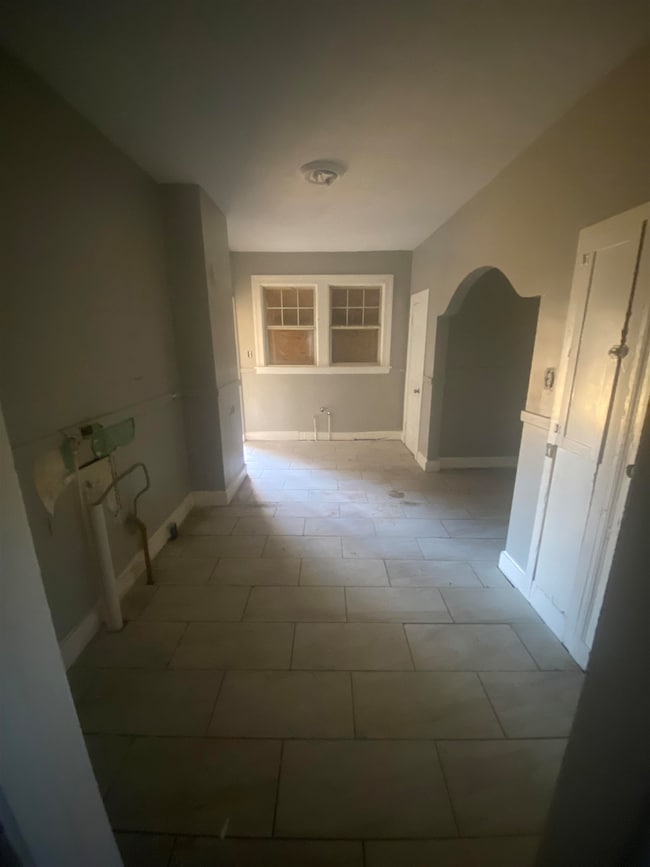 Hall featuring tile flooring