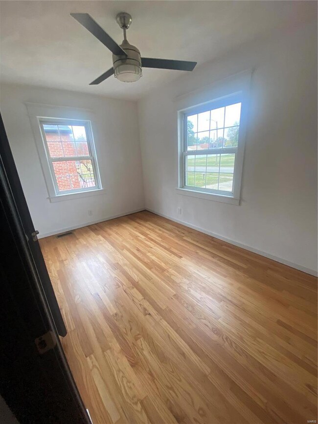 Front bedroom, new fan, walls and refinshed floors.