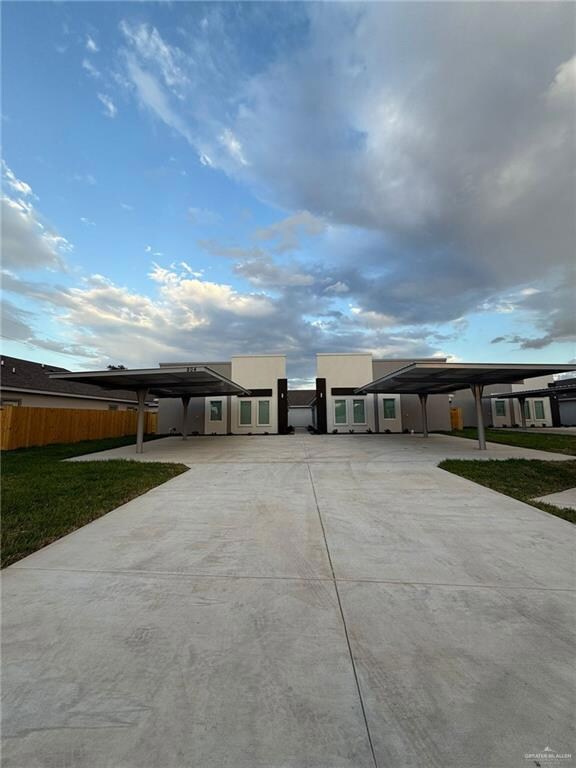View of front of home with a front lawn and a carport