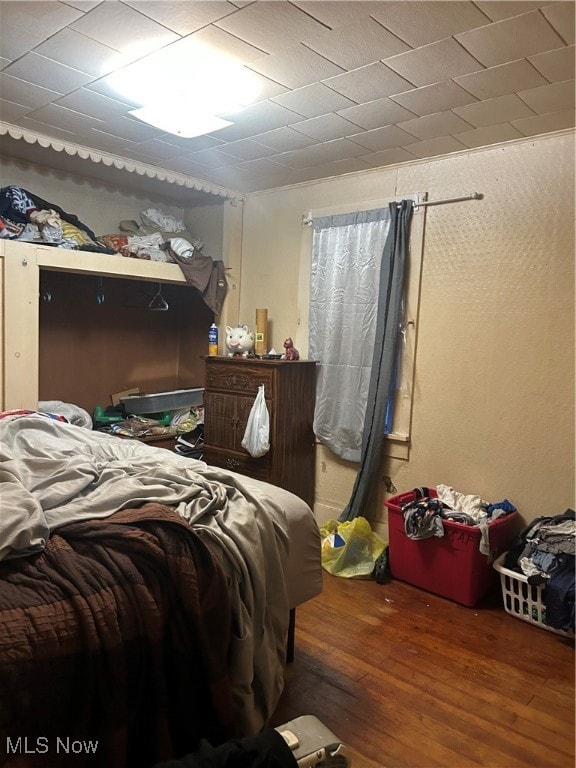 Bedroom with dark wood-style floors