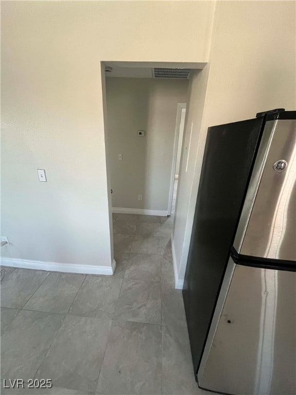 Kitchen featuring freestanding refrigerator and ba