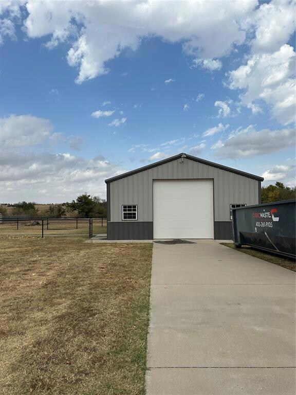 View of outbuilding featuring a rural view and a g