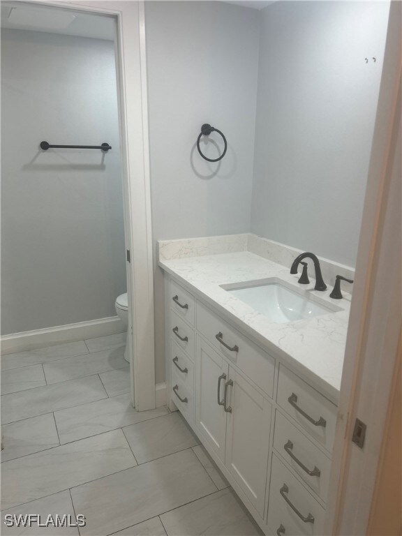 Bathroom featuring vanity and toilet