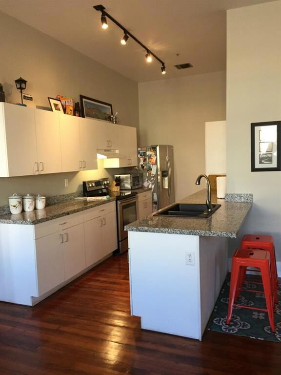 Kitchen boasts a composite granite sink, granite c