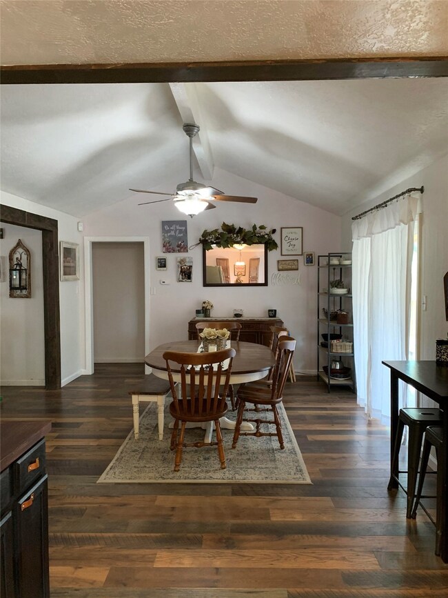 Spacious dining room with vaulted ceilings and access to the backyard