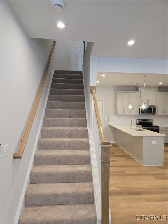 Stairs featuring baseboards, recessed lighting, an