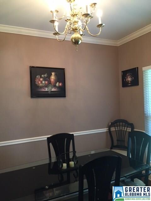 Beautiful room with crown molding and wainscoting.