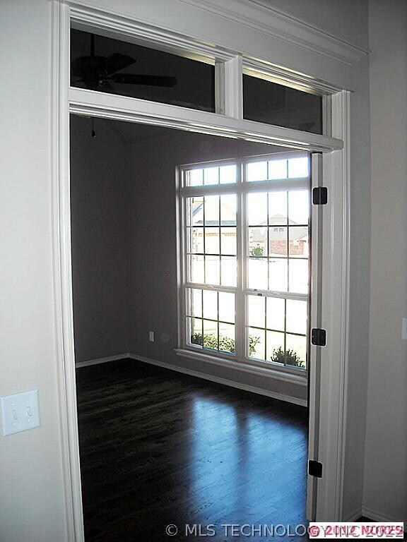 Front facing Study with wood floor and transom win