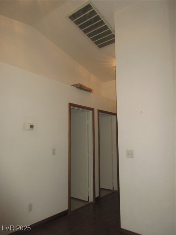 Spare room featuring dark wood-style floors and lo