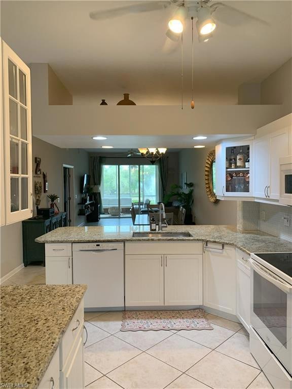 Kitchen with white appliances, glass insert cabine