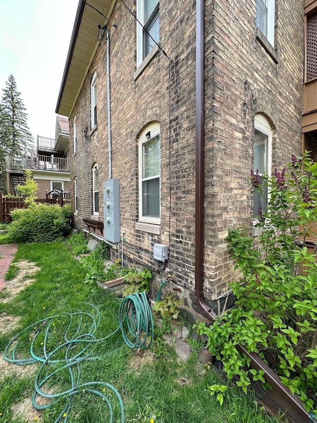 View of side of property with brick siding