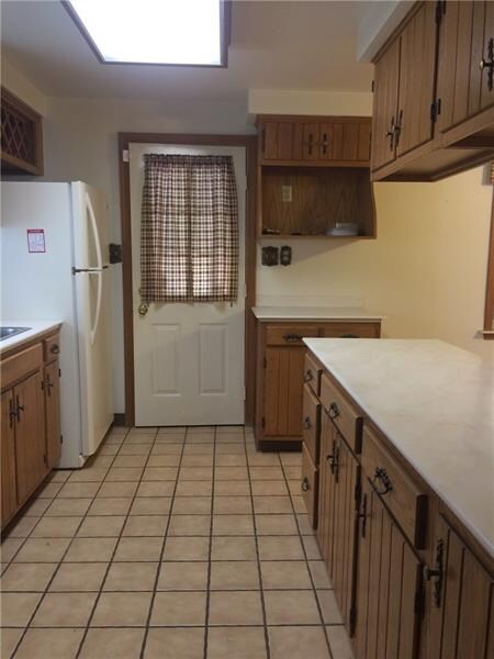 Ceramic tile kitchen floor with door to deck.