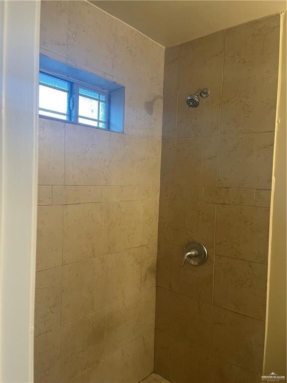 Full bathroom featuring a tile shower