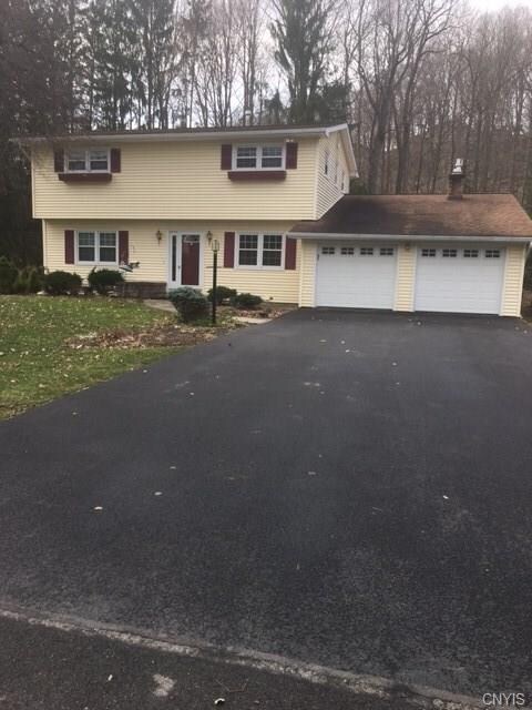Front of house showcasing wide driveway.