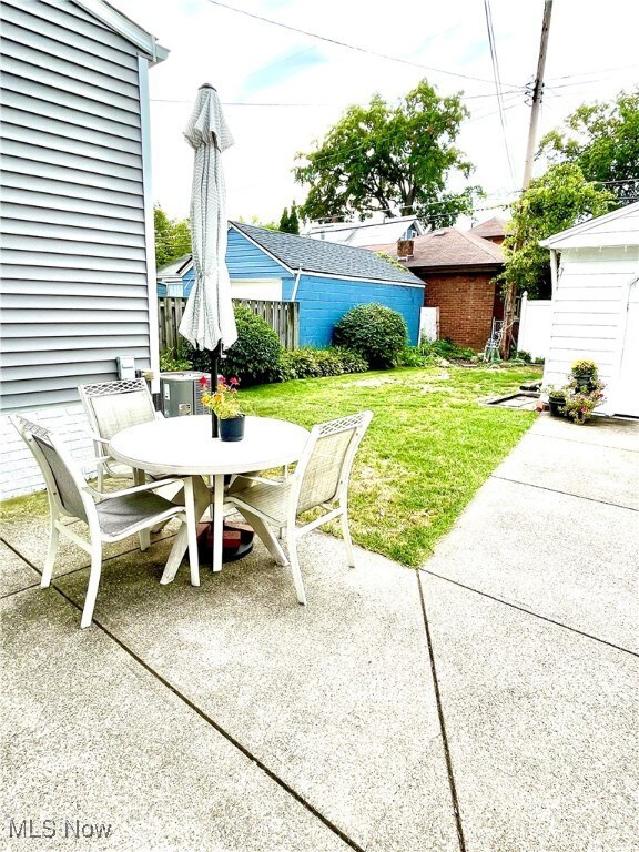 View of back patio space overlooking quiet, private backyard.