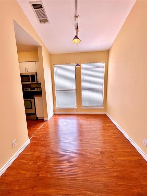 Unfurnished dining area featuring baseboards and 