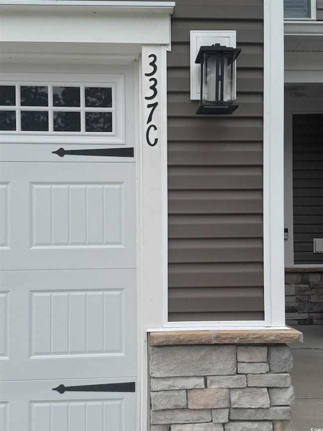 Doorway to property featuring stone siding