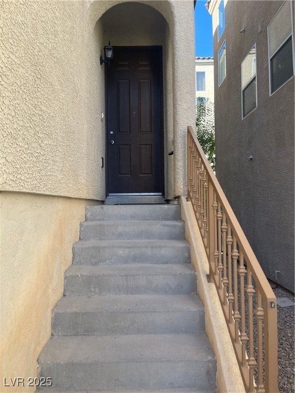Property entrance featuring stucco siding