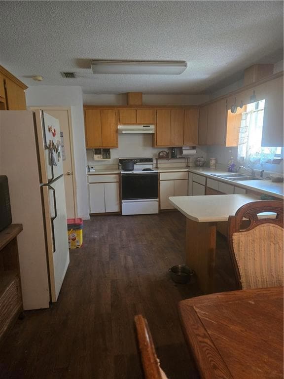 Kitchen with white electric range, refrigerator, l