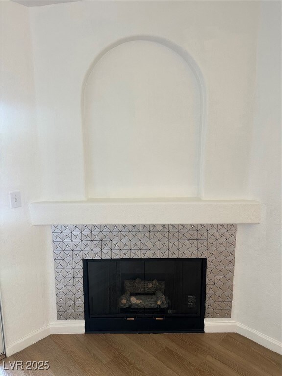 Detailed view of a tiled fireplace and wood finish