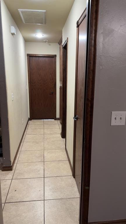Hall featuring light tile patterned floors
