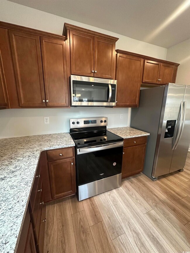Kitchen with stainless steel appliances, light sto