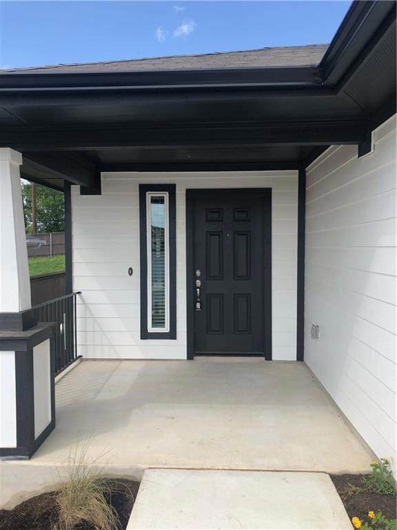 View of exterior entry featuring a porch