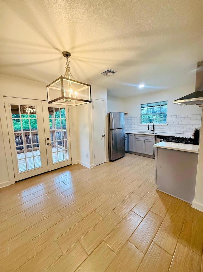 Kitchen with freestanding refrigerator, visible v