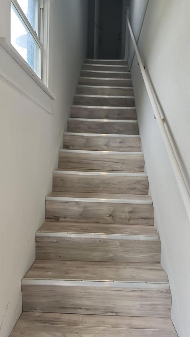 Stairway with hardwood / wood-style flooring
