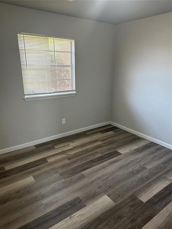 Unfurnished room with dark wood-type flooring and 