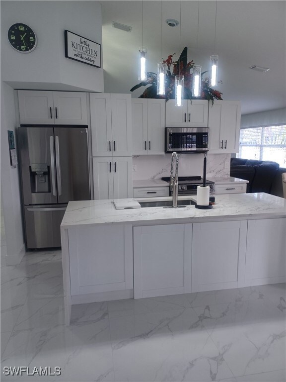 Kitchen featuring appliances with stainless steel