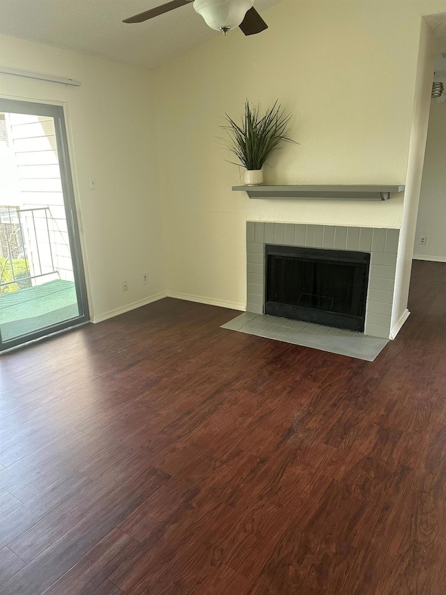 Unfurnished living room with dark wood-style floor