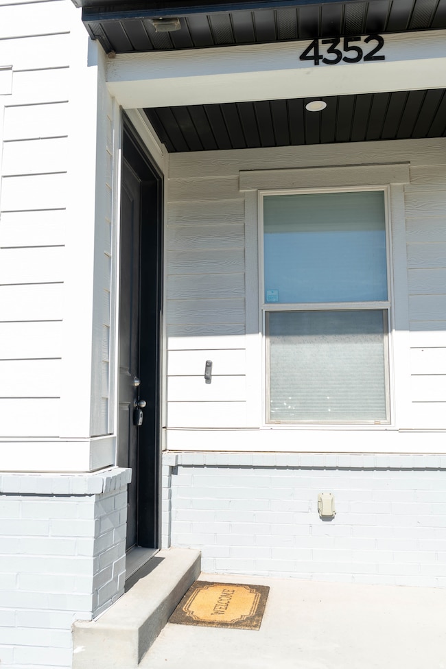 Entrance to property with brick siding
