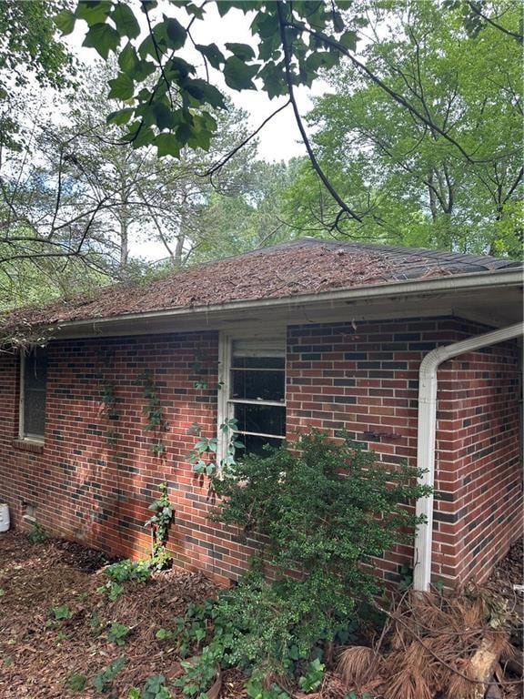 View of property exterior with brick siding