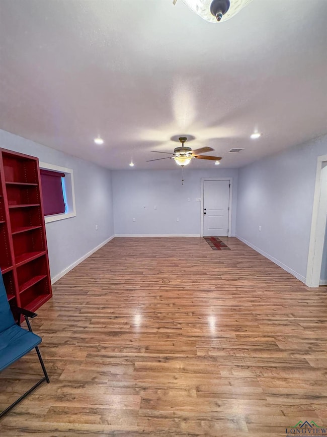Unfurnished living room with light wood-style flooring, a ceiling fan, and recessed lighting
