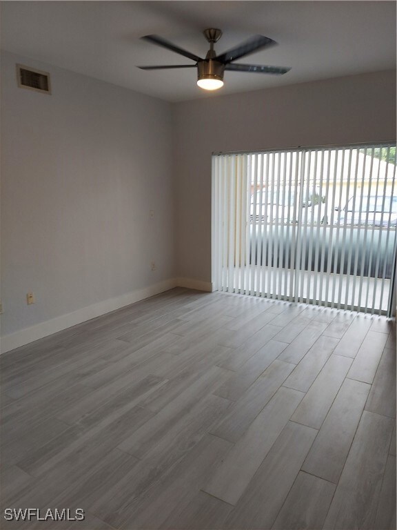 Empty room with light wood-type flooring and ceiling fan