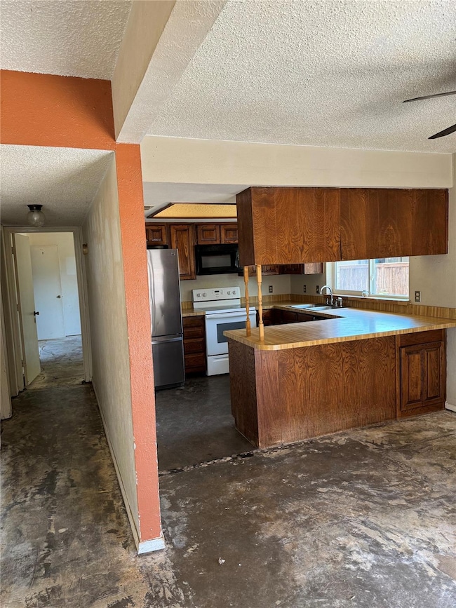 Kitchen featuring electric range, stainless steel 