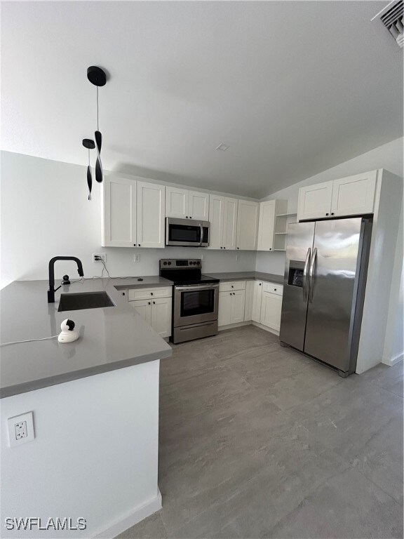 Kitchen with a peninsula, a sink, stove, lofted ce