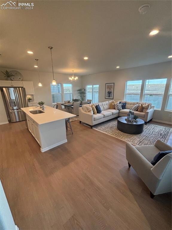 Living room featuring a notable chandelier, a weal