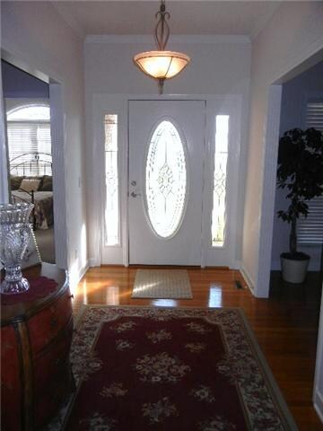 A beautiful way to welcome guests into your home through this beautiful front door onto shining hardwood in a nice wide entry foyer.