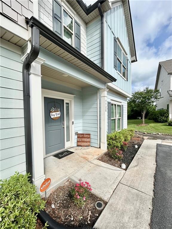 Property entrance with board and batten siding