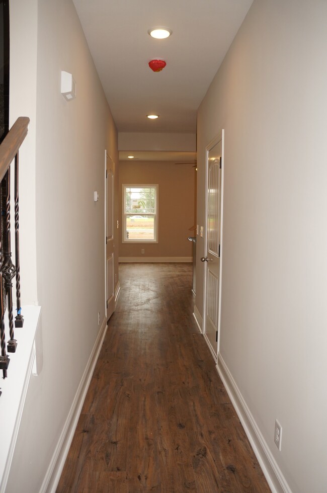 Coming in from the Front Door is the Hallway leading to the Kitchen and Great Room.