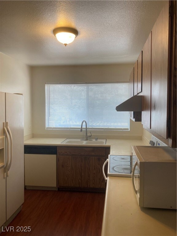 Kitchen featuring dishwasher, fridge, a textured c