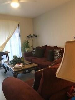 Spacious living area with ceiling fan