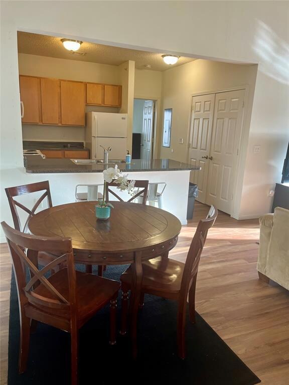 Dining room with light wood-style flooring