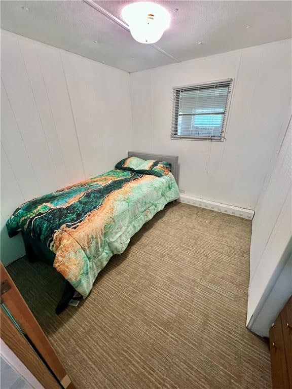 Carpeted bedroom with a textured ceiling