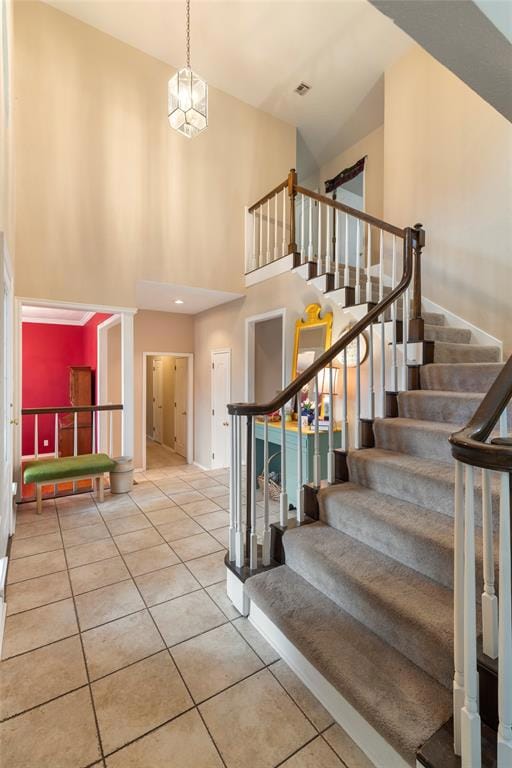 Stairs featuring tile patterned floors, visible ve