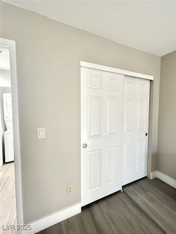 Unfurnished bedroom with stacked washer / drying m