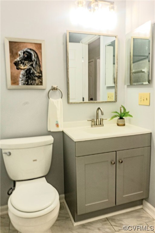 Bathroom with tile flooring, toilet, and vanity